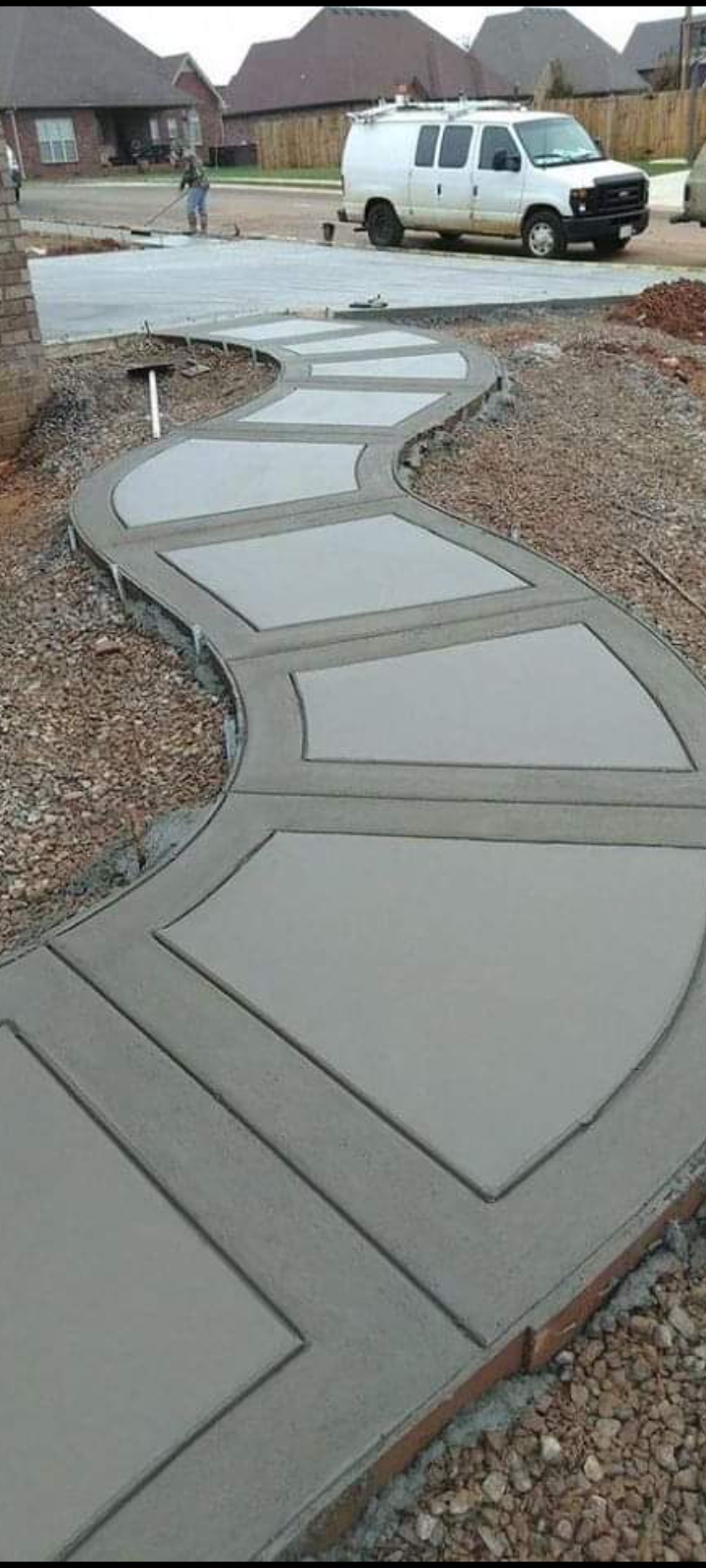 Decorative curved concrete walkway with stamped pattern